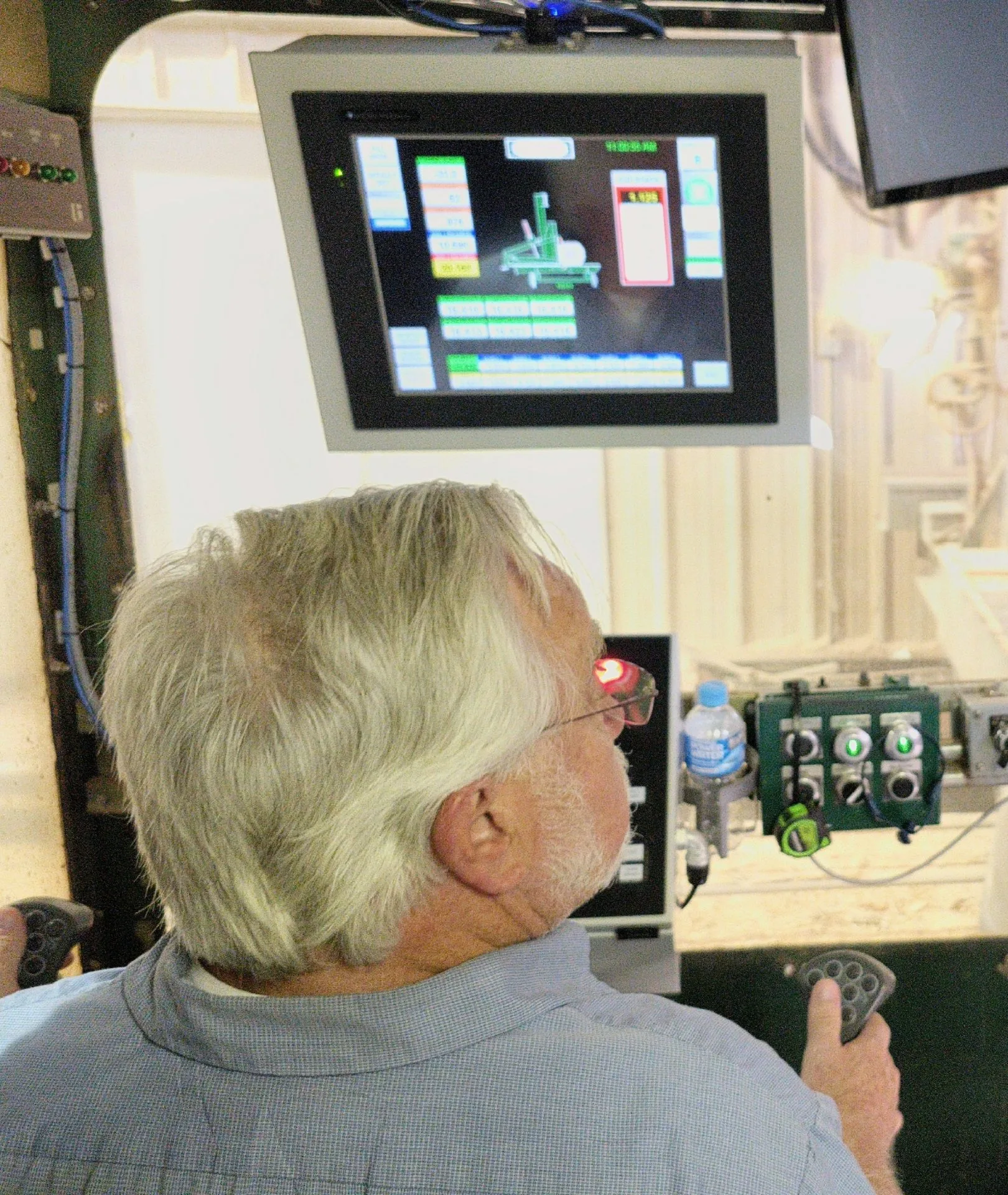 Operator controlling a laser-guided, computer-assisted sawmill system at Turman Forest Products in Hillsville, Virginia, combining advanced technology with skilled craftsmanship in sustainable hardwood manufacturing.